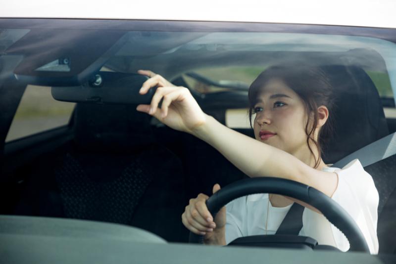 female-driver-adjusting-rear-view-mirror