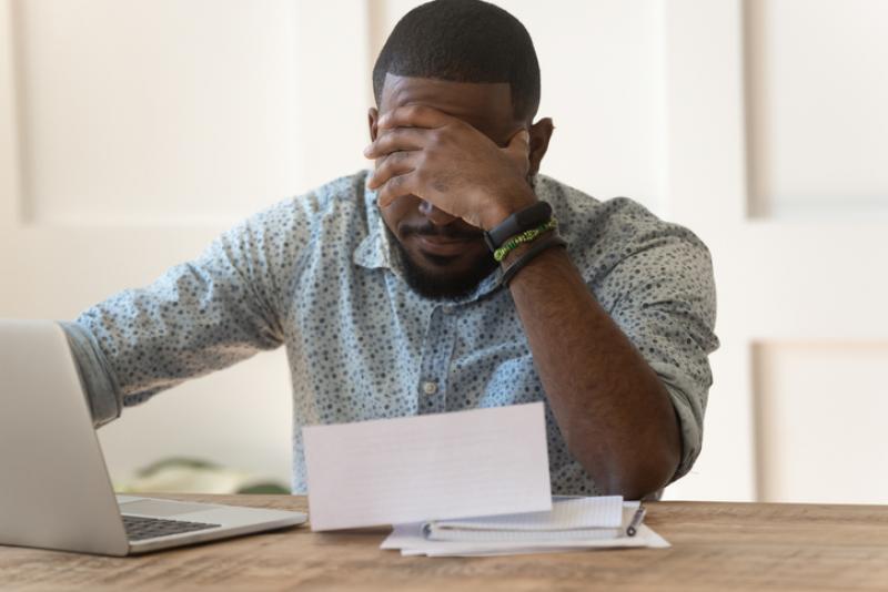 man worrying about debt