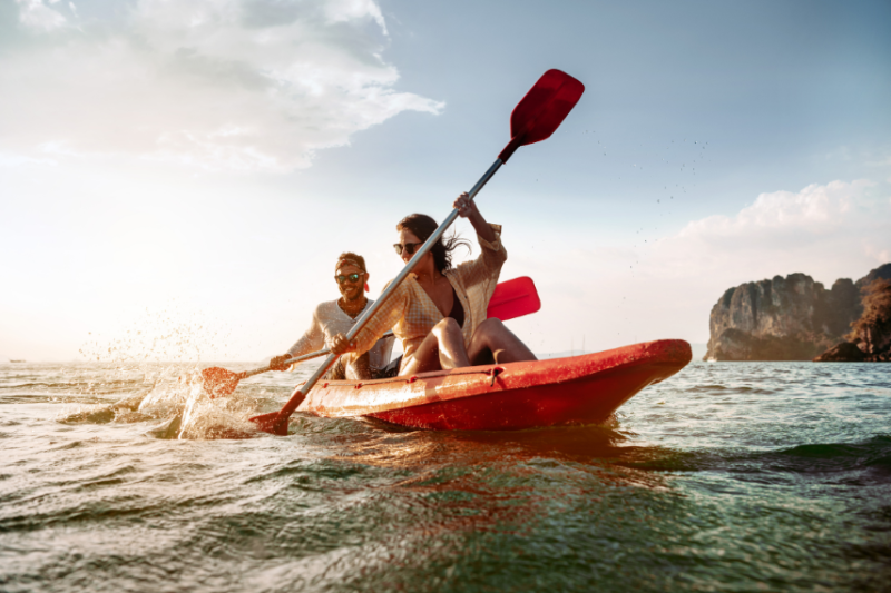 A man and woman kayaking in the sea