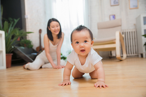 A baby crawling towards camera