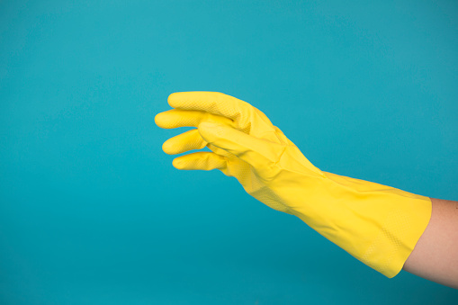 A yellow gloved hand