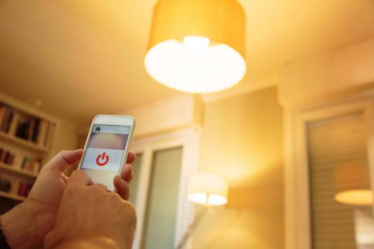 a-person-operating-a-light-with-their-smart-phone