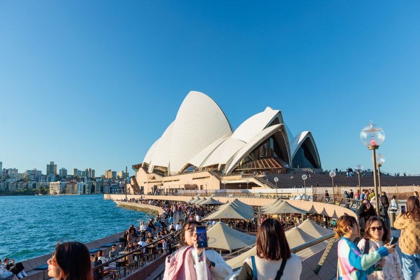 Crowds of people taking photos of the Sydney Opera House