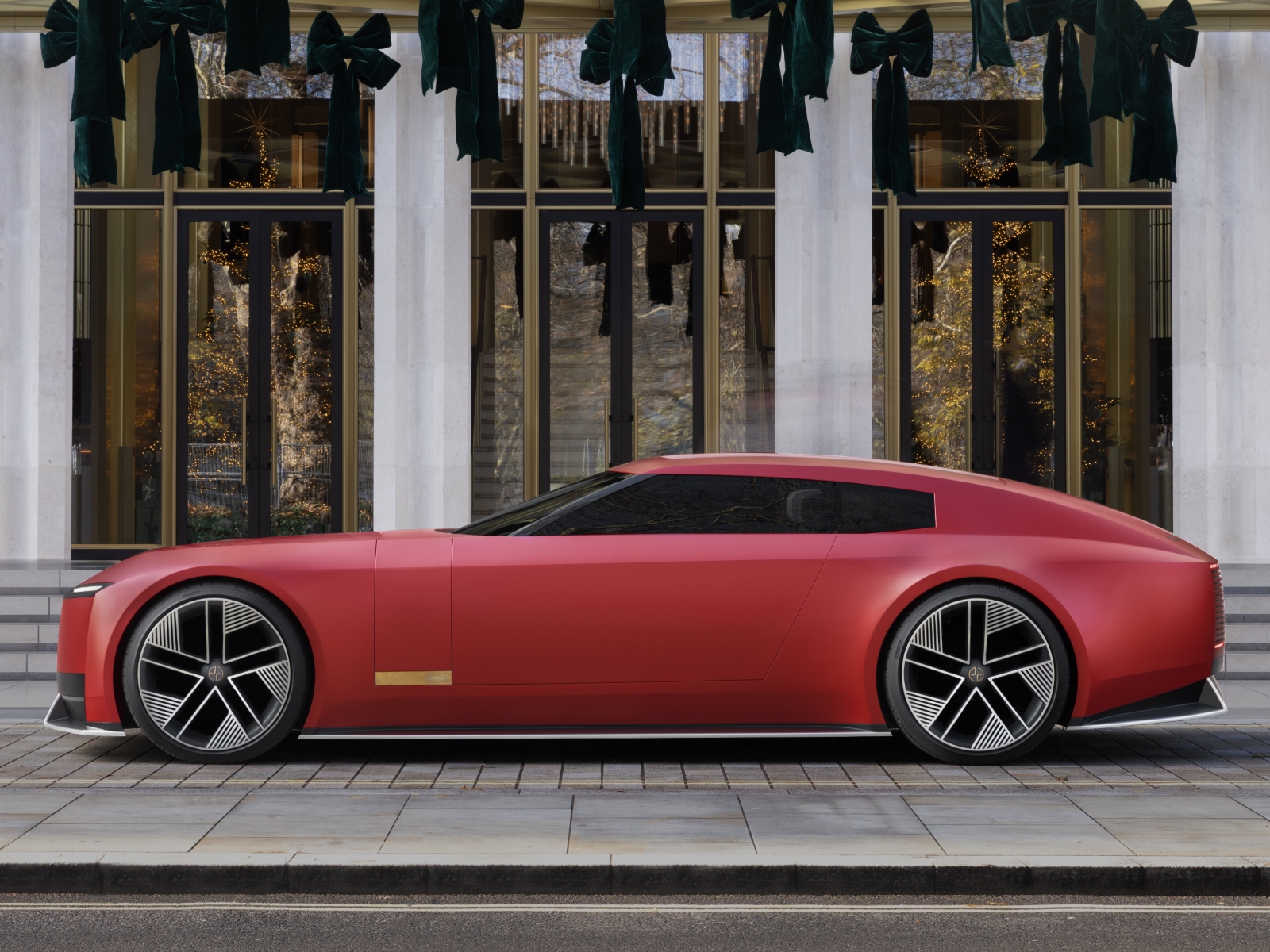 A red Jaguar Type 00 parked in front of a shop