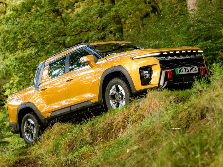 A yellow KGM Musso EV car