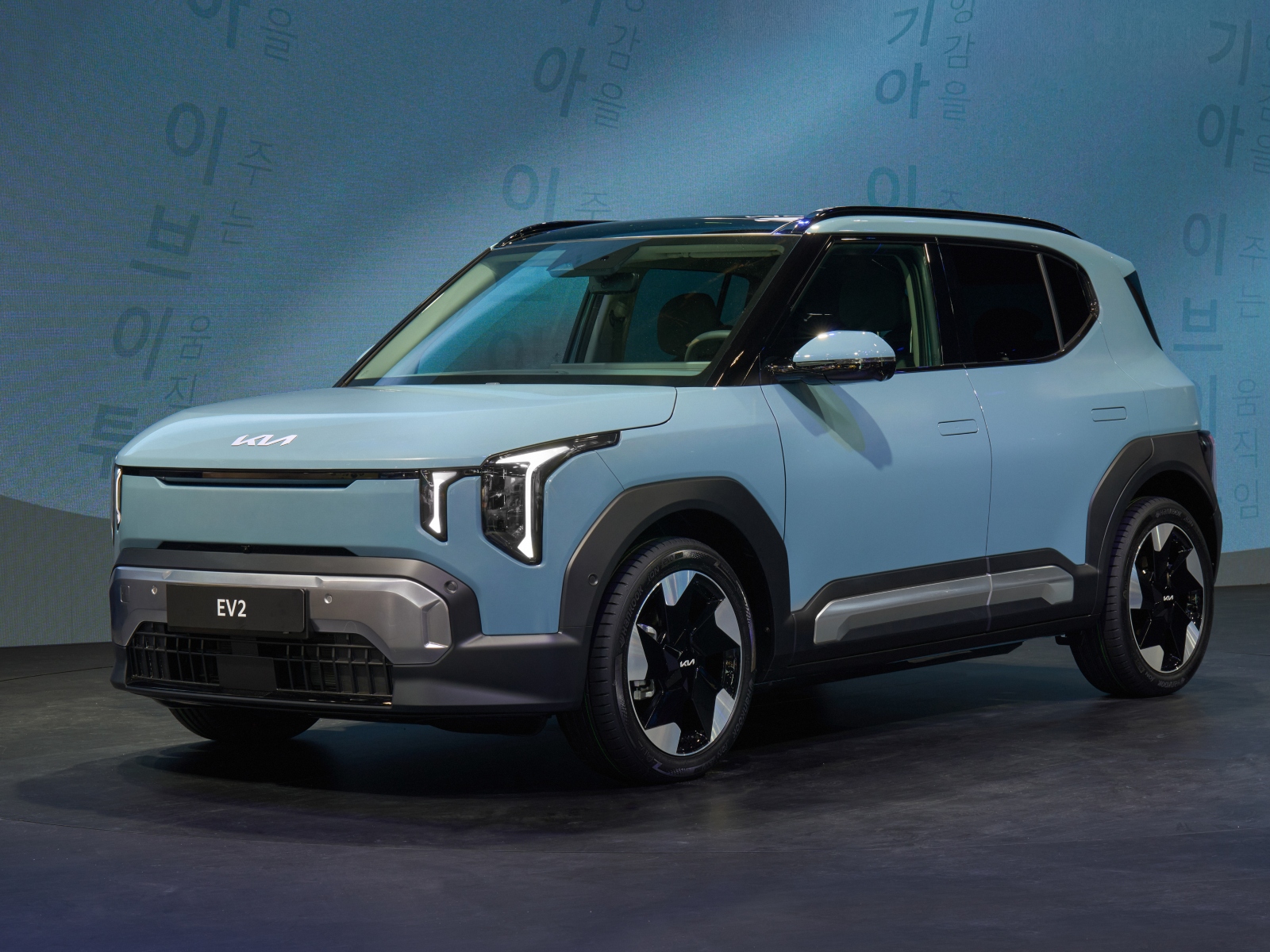 A light blue/grey Kia EV2 car