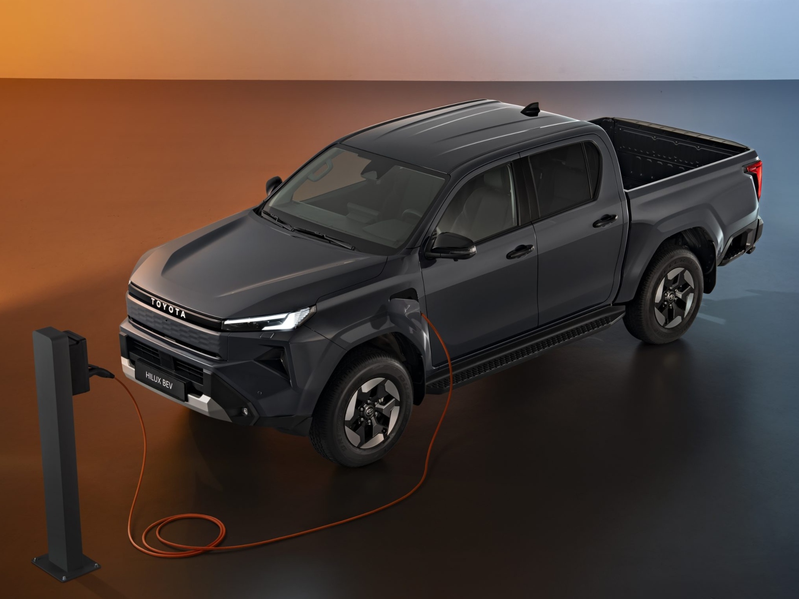 A black Toyota Hilux EV truck