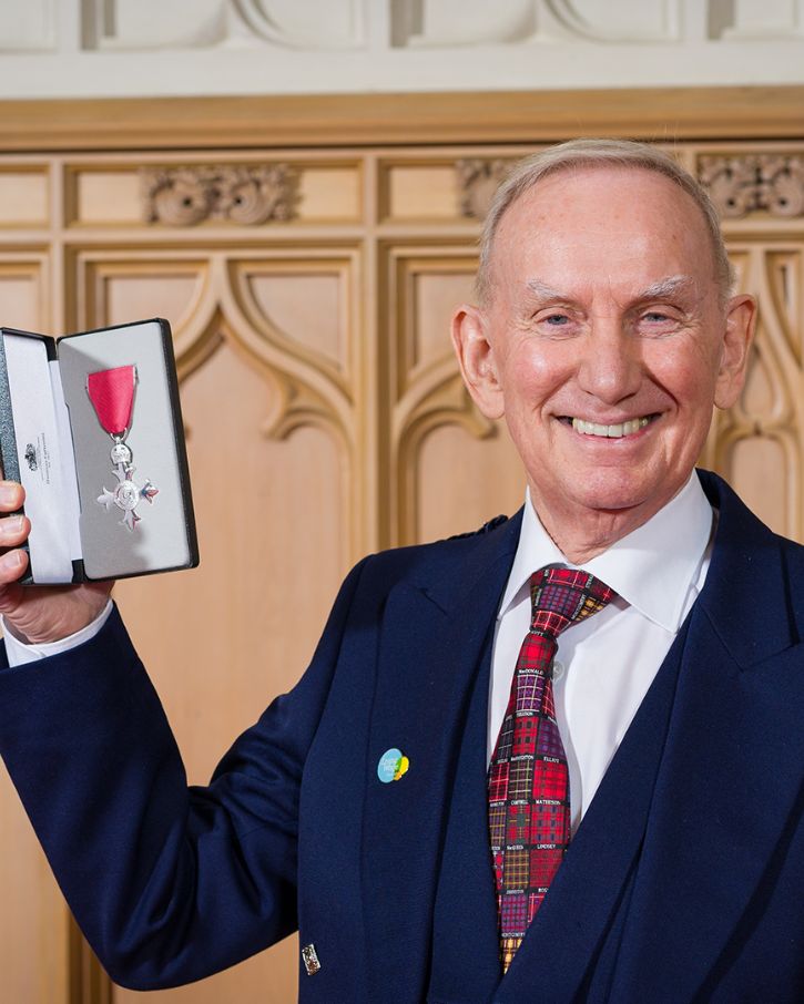 John Burns holding a medal