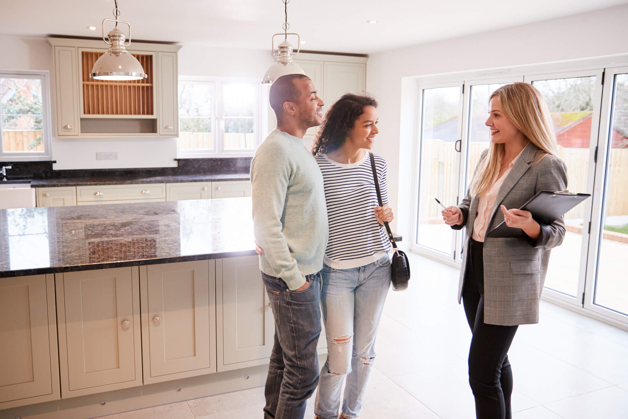 couple viewing house with estate agent