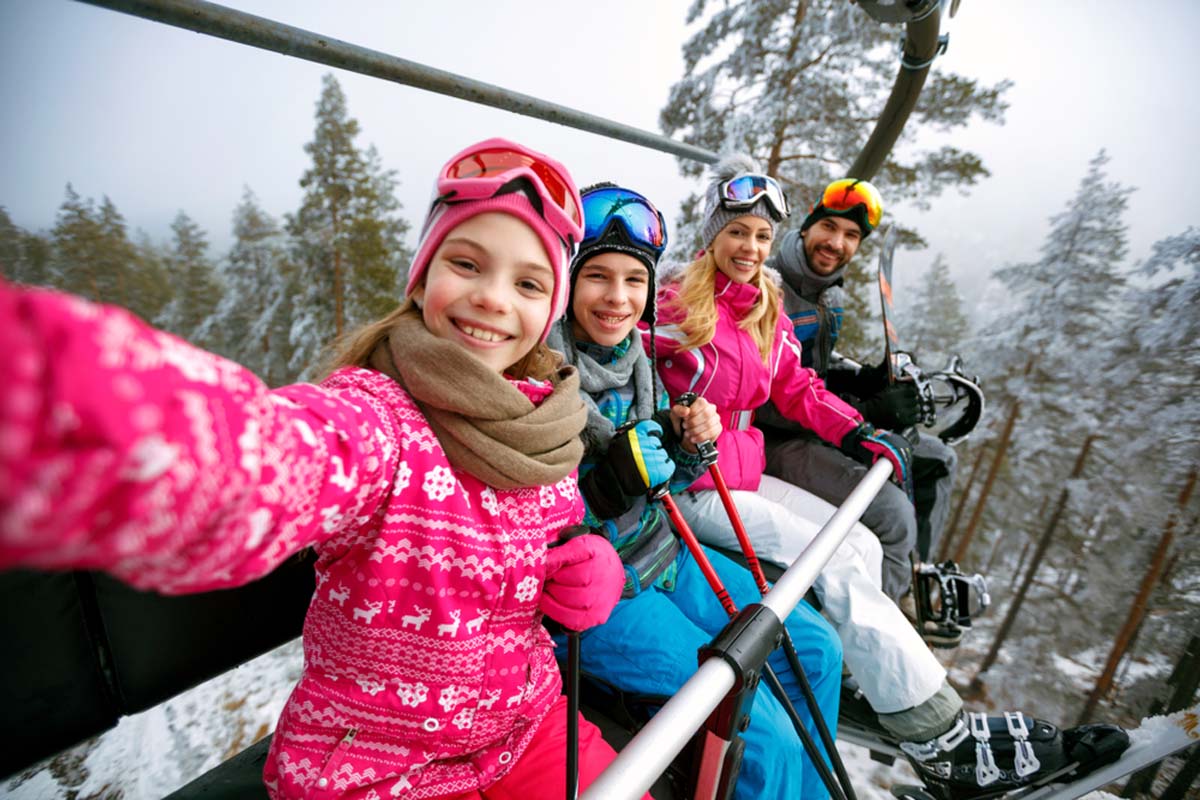 family-on-a-ski-chair-lift-taking-a-selfie