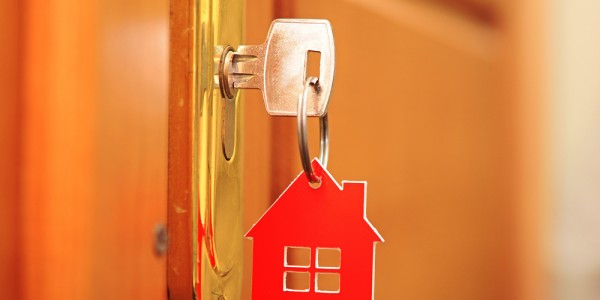 A key with a house shaped keychain

Description automatically generated