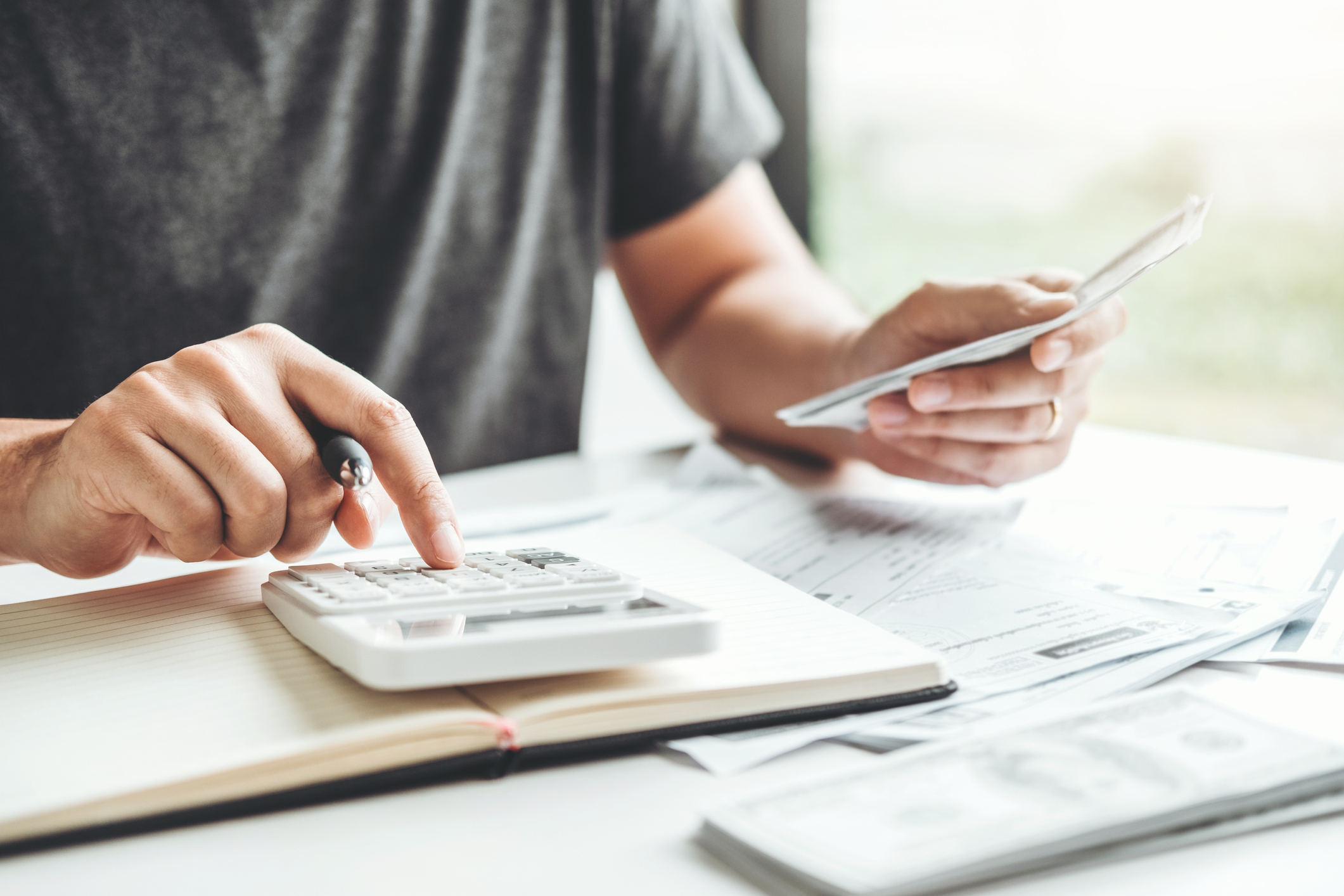 man working out finances