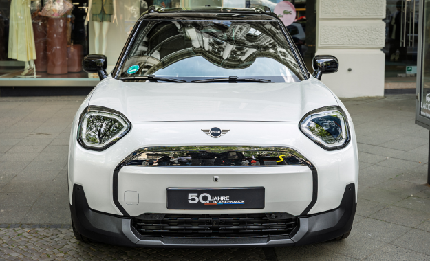 white mini aceman parked on street
