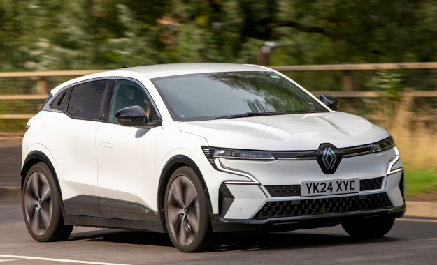 white renault megane etech driving on road