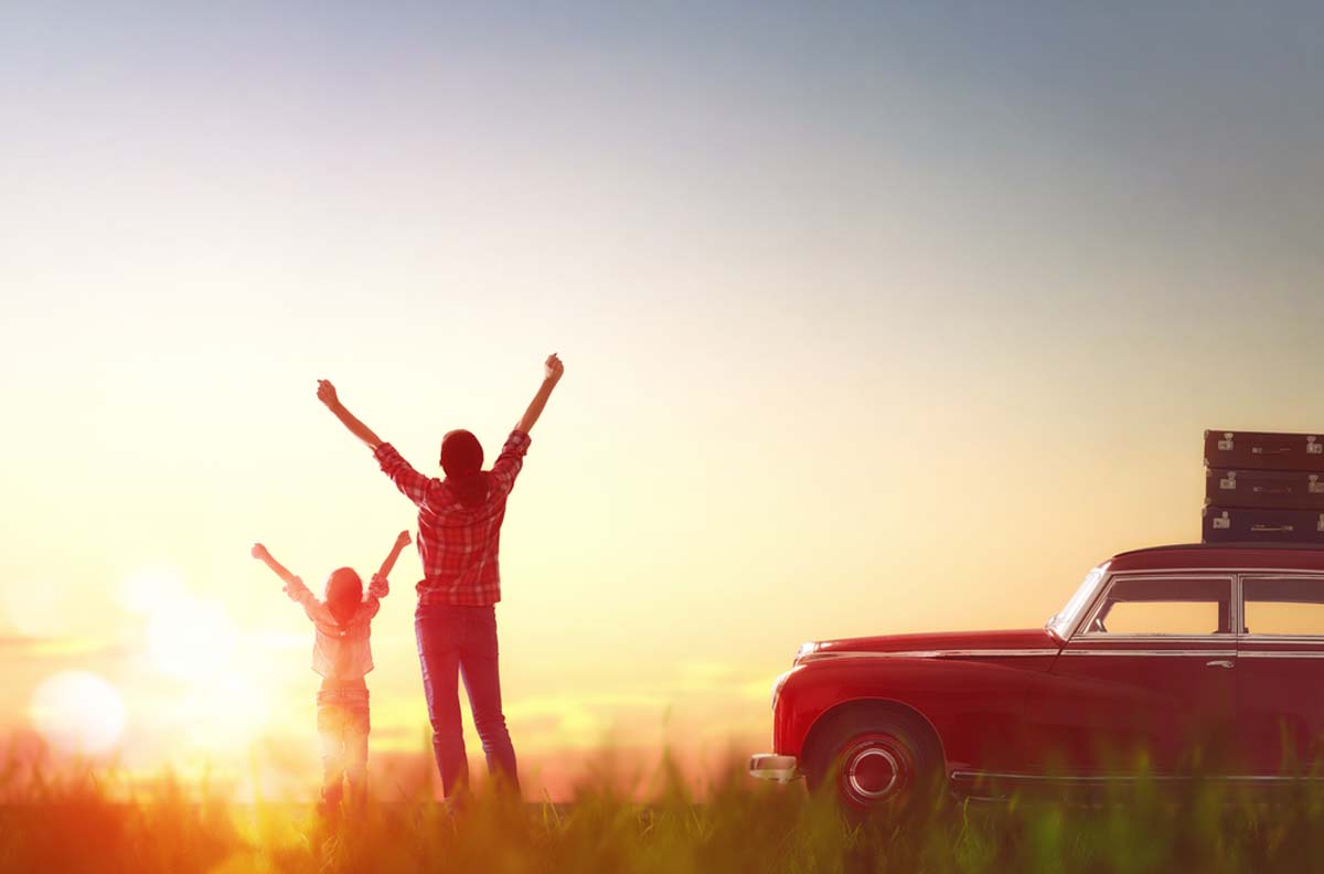 silhouette-of-a-parent-and-child-celebrating-arriving-at-their-destination