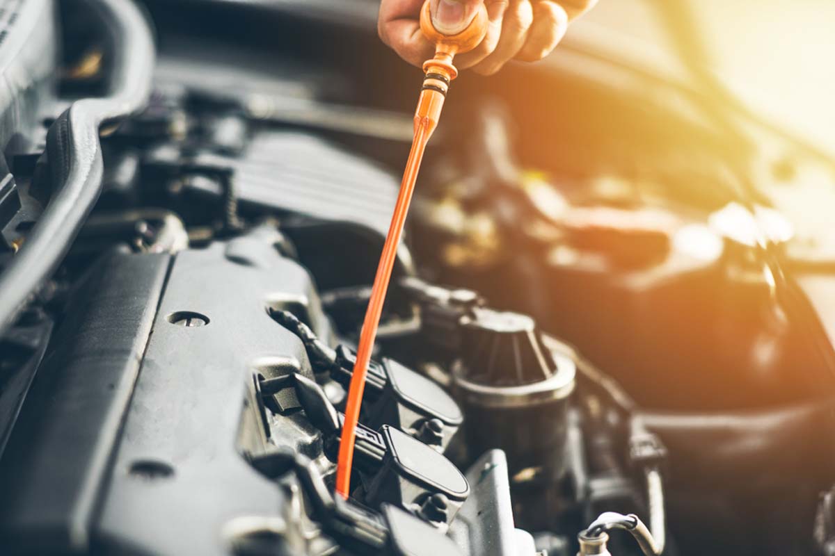 man-checking-oil-in-a-car