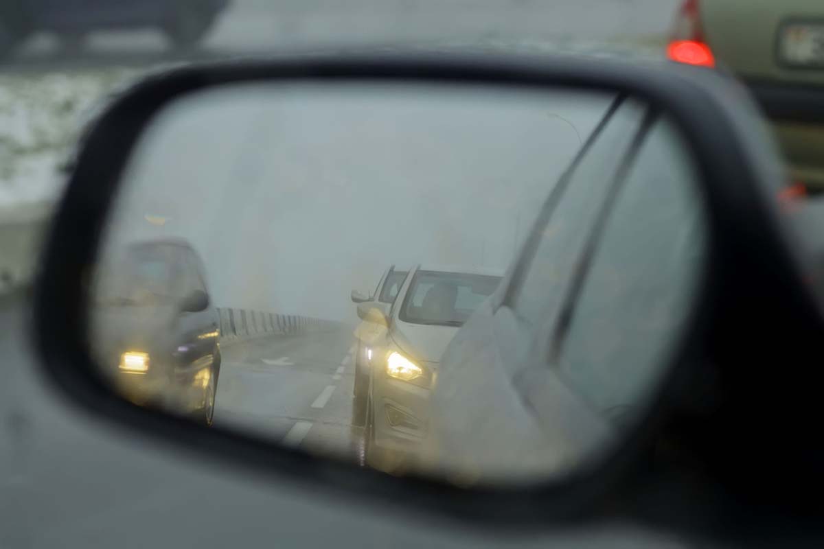 view-in-the-wing-mirror-of-cars-on-the-road-in-fog