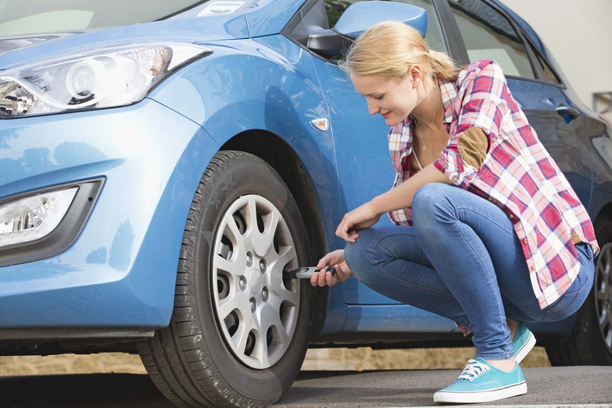 woman-checking-tyre-pressure