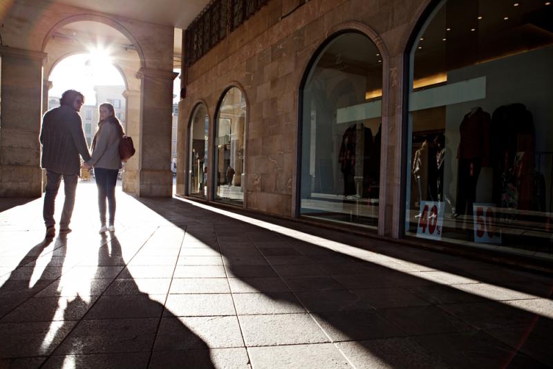 couple=on-holiday-walking-down-a-street