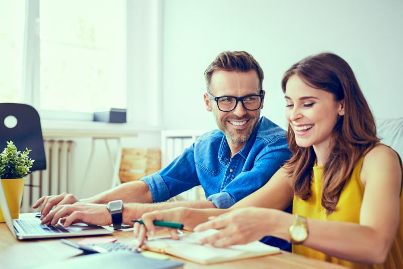 couple-sitting-at-a-table-organising-their-finances
