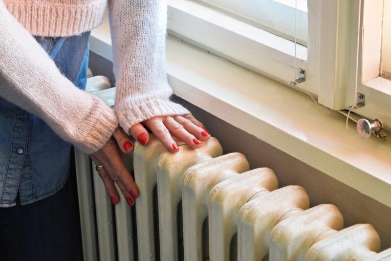 a-womans-hands-on-radiator