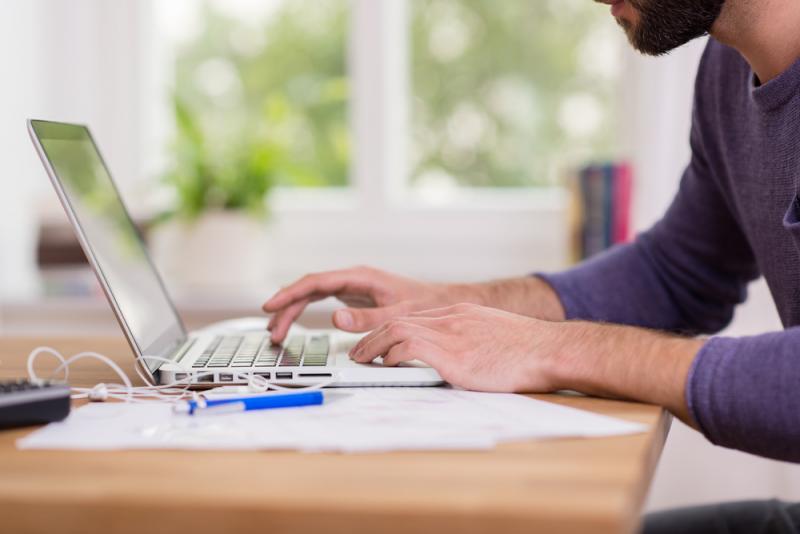 bearded-man-working-from-home-at-his-laptop
