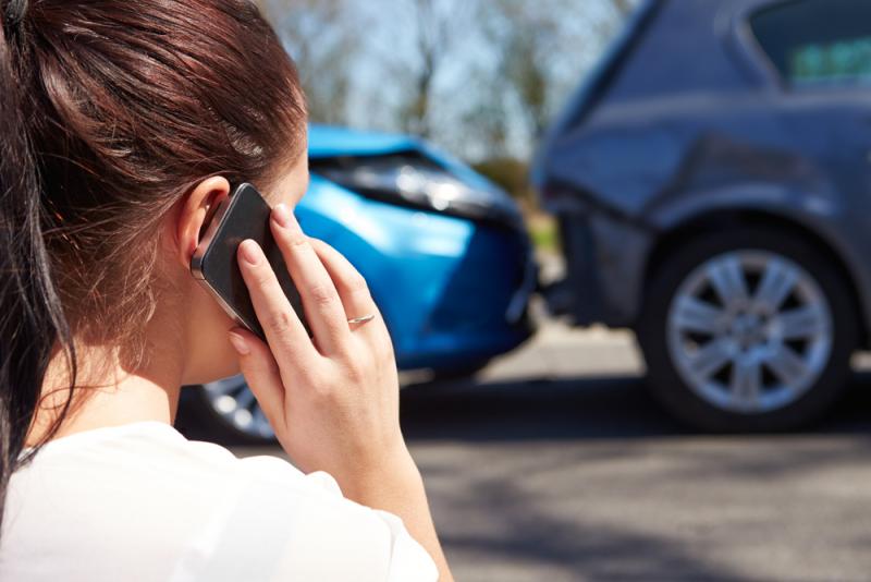 woman-using-her-mobile-phone-after-a-car-accident