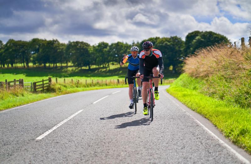 two-cyclists-on-a-country-road