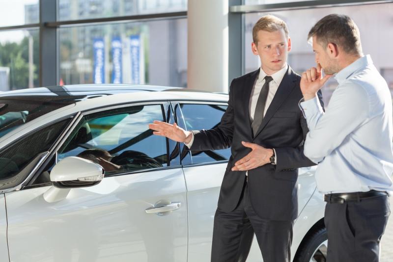 car-salesman-showing-a-car-to-a-man