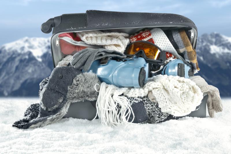open-suitcase-on-snow