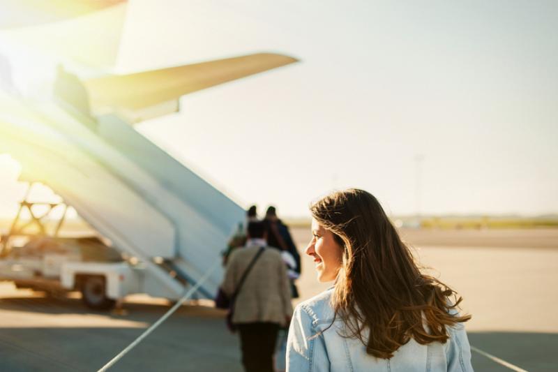 Woman boarding plane