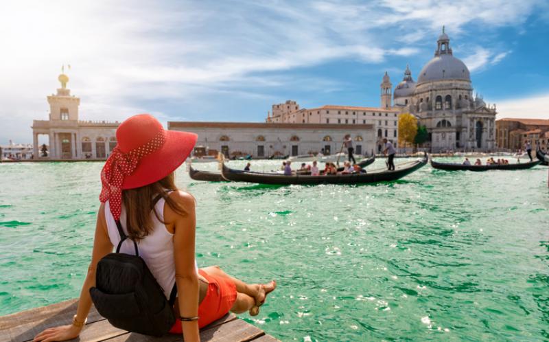 A woman sitting on a bay in Venice