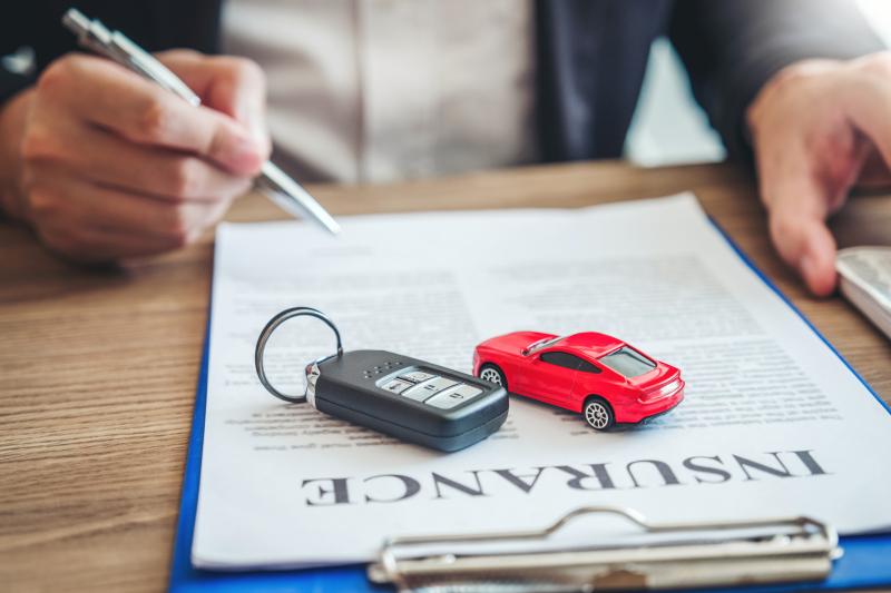 car-insurance-documents-with-car-key-and-model-car