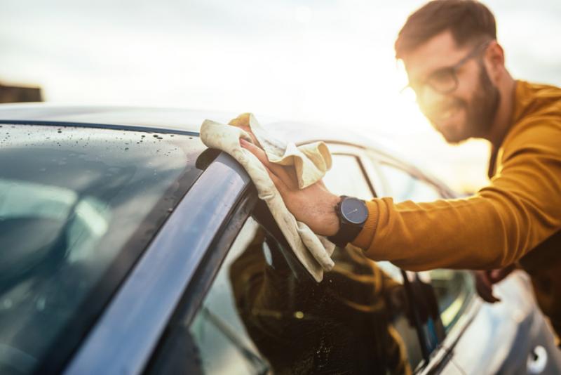 man-polishing-car