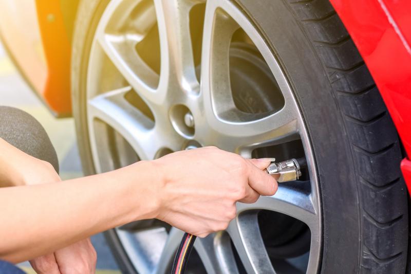 woman checking tyre pressure
