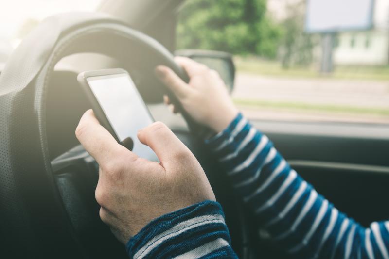 woman texting while driving