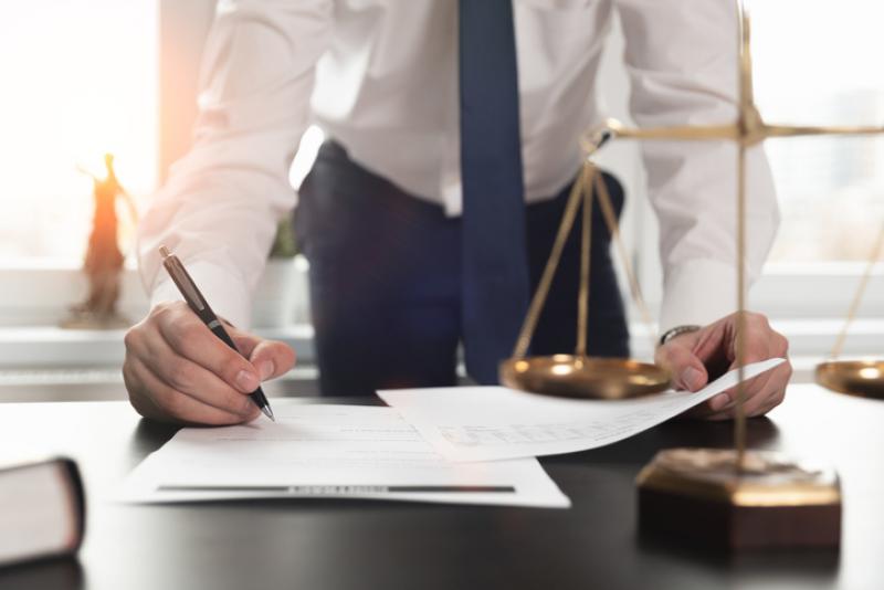 solicitor working on documents at desk