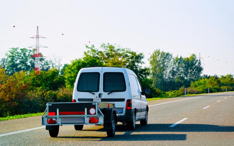 small van towing a trailer