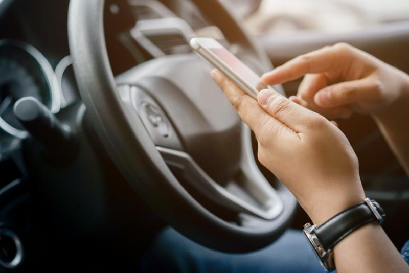person using mobile phone while driving
