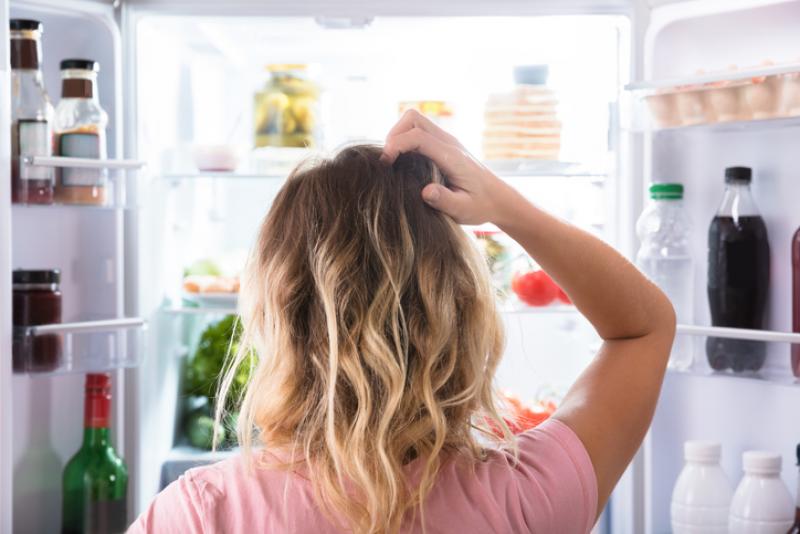 A woman looking into a freezer