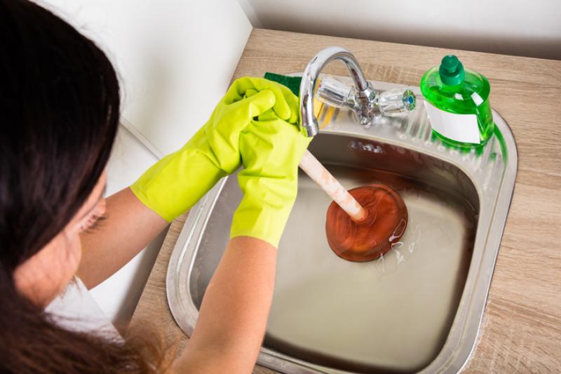 unblocking a sink with a plunger