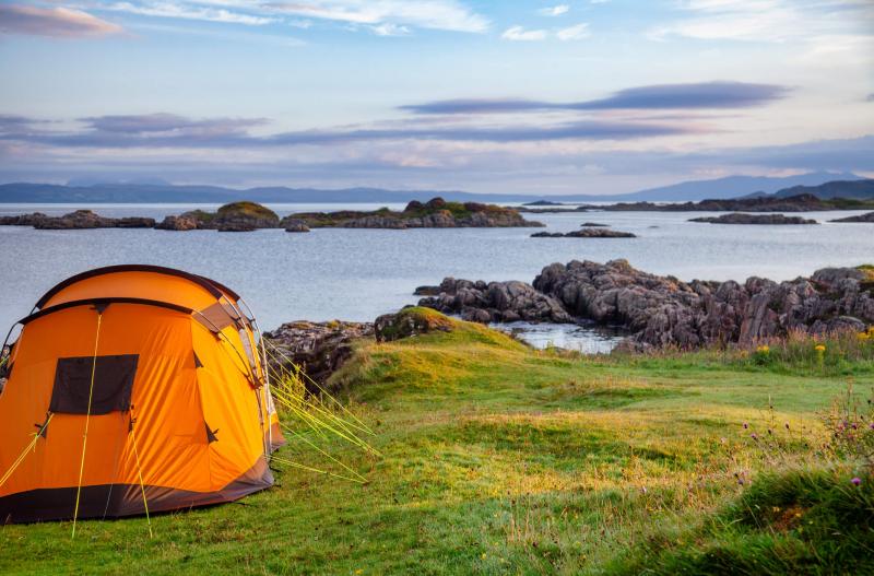 tent in countryside near a lake