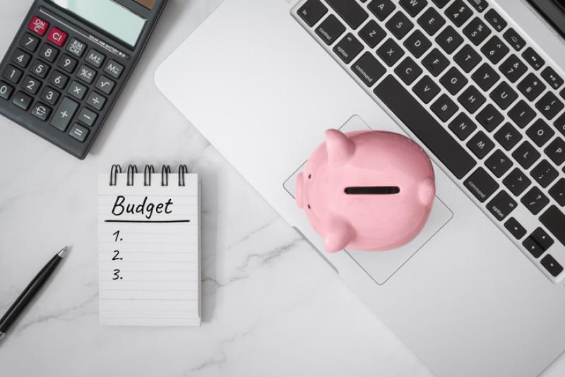 notebook and piggy bank on laptop