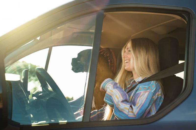 Woman and dog in a van