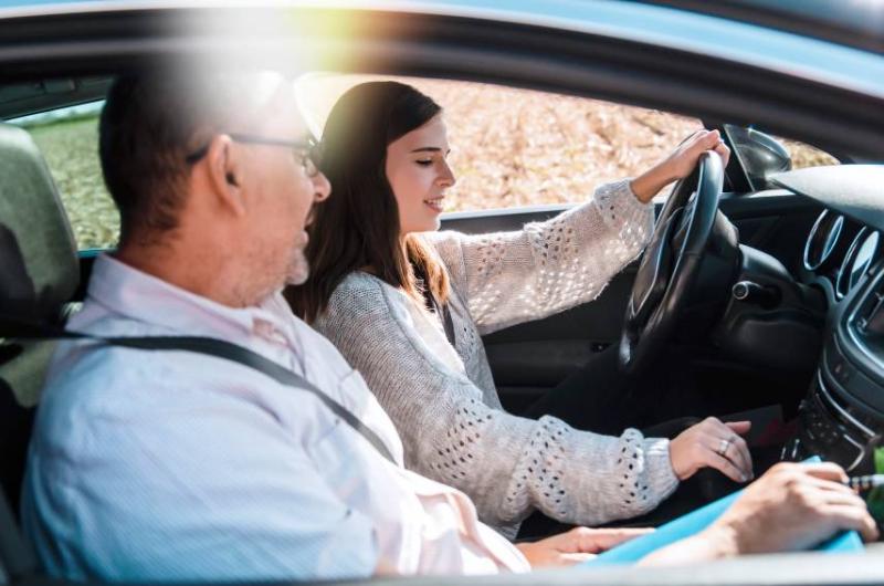 Image of a learner driver in a car with her instructor