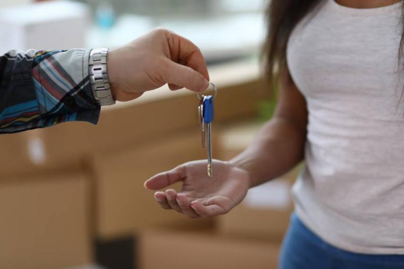 Image of tenants receiving keys to their property.