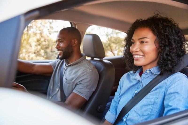 Image of an adult couple driving a car.