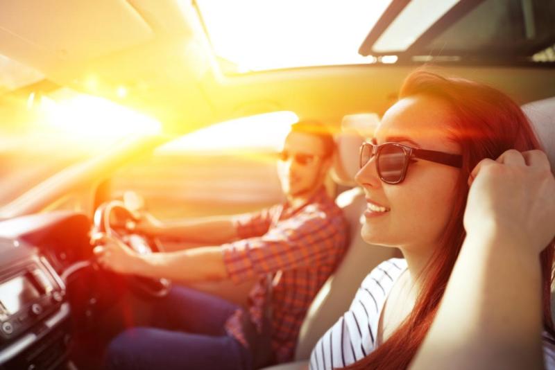 couple driving in the sun