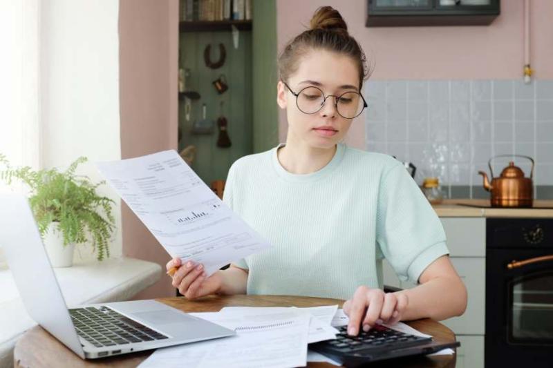 image of a woman paying her car insurance bills