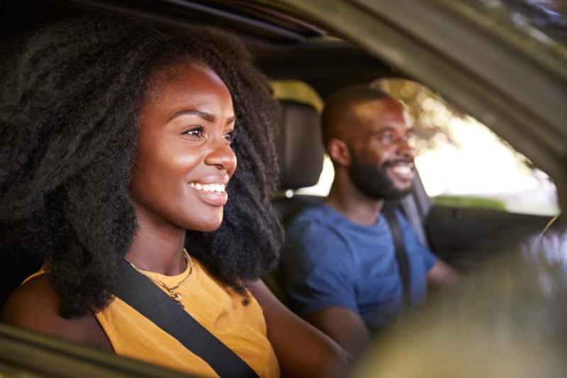 Image of a couple in a car with the woman driving